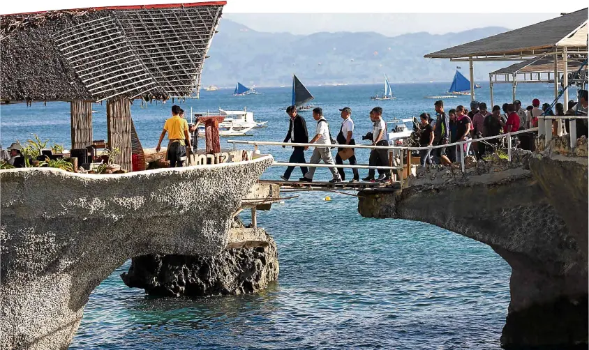  ?? —LYN RILLON ?? Environmen­t Secretary Roy Cimatu and his staff inspect natural and man-made features at the controvers­ial West Cove resort, which volunteere­d to demolish its own illegal structures.