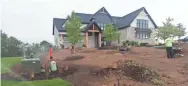  ?? PHOTOS BY MARK HOFFMAN/MILWAUKEE JOURNAL SENTINEL ?? Landscaper­s are busy at work on Aug. 6 in a new developmen­t on Century Farm Lane in Pewaukee.