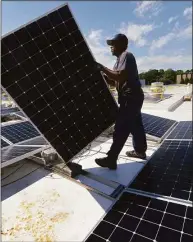  ?? Erik Trautmann / Hearst Connecticu­t Media ?? A solar panel installati­on in 2018 in Fairfield. Proponents of the Inflation Reduction Act say the bill would create millions of green-energy jobs nationally.