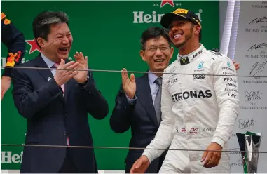  ??  ?? BIG WIGS AND FAST DRIVERS: Lewis Hamilton on the podium after winning the 2017 Chinese Formula One Grand Prix at the Shanghai Internatio­nal circuit yesterday.