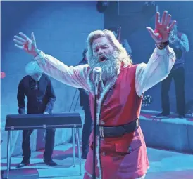  ??  ?? Santa jams with a prison soul band. “He’s out there with a purpose, and it’s not just to give gifts away,” Russell says.