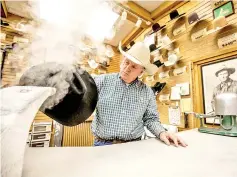  ??  ?? Sorrell shapes a hat for a customer in his booth at Langston’s Western Wear.