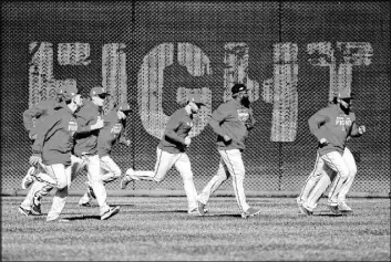  ?? Patrick Semansky The Associated Press ?? Members of the Washington Nationals get in some running during Friday’s workout.