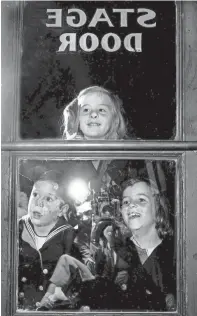  ?? BOB ?? Just a few of the younger set on hand in October 1950 to see their parents become theatrical folk for an evening were, from left, Frank Crump III, Sally Crump and Marie Louise Crump, children of Mr. and Mrs. F.M. Crump Jr. And that’s staff photograph­er Bob Williams reflected in the glass as he took the photograph. WILLIAMS / THE COMMERCIAL APPEAL