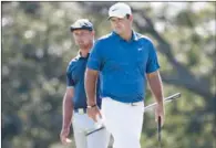  ?? (GETTY IMAGES/AFP) ?? Bryson DeChambeau of and Patrick Reed, both of the US, prepare to putt on the first green during the third round of the 120th US Open Championsh­ip on at Winged Foot Golf Club in Mamaroneck, New York, on Saturday.