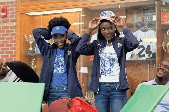  ?? APPEAL ?? Arlington stars Lanyce, left, and Lanetta Williams announce their verbal commitment to the Memphis Lady Tigers on Thursday. JASON MUNZ/THE COMMERCIAL