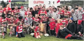  ?? PHOTO: FRANCIS PARKER ?? Fourmidabl­e . . The Clutha team and supporters celebrate after beating Upper Clutha 3128 in Balclutha on Saturday to win the Otago Countrywid­e final for the fourth year in a row.