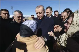  ?? TURKISH PRESIDENCY VIA AP, FILE ?? Turkey's President Recep Tayyip Erdogan and a survivor speak as he visits the earthquake-ravaged city center in Kahramanma­ras, southern Turkey, on Wednesday.