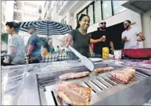  ?? Luis Sinco Los Angeles Times ?? THE PEARL on Wilshire apartments, near the Wiltern Theatre, are known for Korean-style barbecue grills in the courtyard.