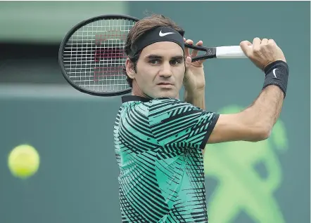  ?? — GETTY IMAGES ?? Roger Federer in action against Frances Tiafoe in the Miami Open on Saturday in Key Biscayne, Florida. Federer continued his 2017 dominance by winning 7-6 (2), 6-3.