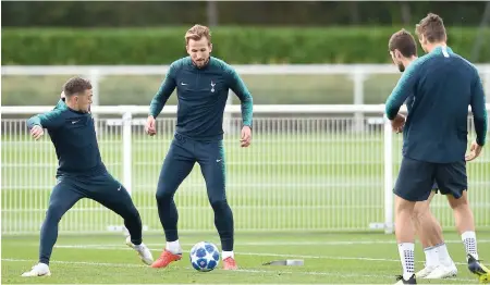  ?? AFP ?? Tottenham Hotspur players Kieran Trippier ( left) and forward Harry Kane ( second from left) take part in their training session at Enfield Training Centre, north London, on Tuesday, eve of their UEFA Champions League Group ‘ B’ match against Barcelona. —