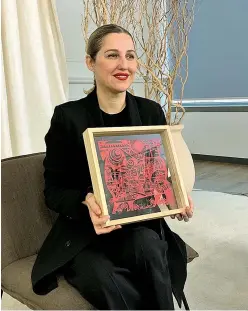  ??  ?? Eva Serrano, president of Inditex China, receives a papercutti­ng work from local artist Li Shoubai as a gift to celebrate the Chinese New Year. The gift is sent by the Shanghai People’s Associatio­n for Friendship with Foreign Countries to some senior executives of multinatio­nal companies in Shanghai.