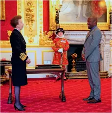  ??  ?? Giles finally receives the insignia for the MBE he was awarded last year from the Princess Royal (above) at St James’s Palace in a socially distanced ceremony last week; and (far left) in one of musical theatre’s most demanding roles as Aaron Burr on stage in London with the cast of Hamilton in 2017