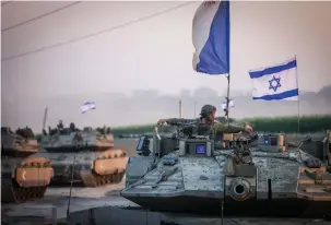  ?? (Chaim Goldberg/Flash90) ?? A CONVOY of Israeli tanks near the border with Gaza: For Israel, this is a mission of self-defense, the writer asserts.