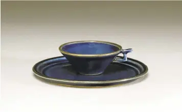  ??  ?? A porcelain cup and saucer with cobalt glaze and gilt decoration from Jiangxi province — dating from the Yuan dynasty (1271-1368), is another one of the pieces on display.