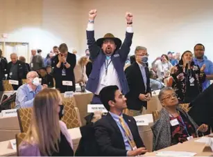  ?? MATT ROURKE AP ?? Committee member Manny Crespin of New Mexico reacts after a vote Saturday for a new calendar lineup for the early stages of the Democratic Party’s presidenti­al nominating contests.