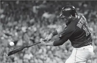  ?? JOHN MINCHILLO/AP PHOTO ?? Boston’s Rafael Devers hits a three-run homer Friday off the Reds’ Sal Romano during the fourth inning in Cincinnati. The Red Sox won, 5-4, to open a four-game lead in the American League East.