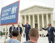  ?? [AP PHOTO] ?? Illinois Gov. Bruce Rauner gives a thumbs up outside the Supreme Court, Wednesday. From left are, Liberty Justice Center’s Director of Litigation Jacob Huebert, plaintiff Mark Janus, Rauner, and Liberty Justice Center founder and chairman John Tillman....