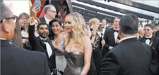  ?? Eric Mccandless ?? ABC Jennifer Lawrence walks the red carpet at Sunday’s Oscars. If you’re not a celeb, accessing the Oscars is like going through the world’s most glamorous airport security line.