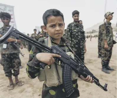  ??  ?? 0 A child soldier in Huthi forces in Yemen, one of 350 million children who live in a conflict zone worldwide