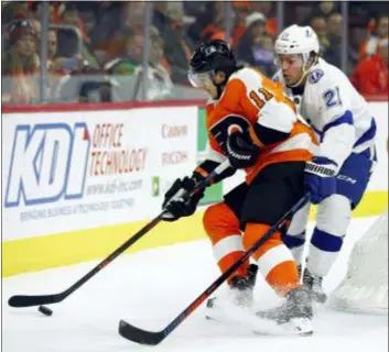  ?? TOM MIHALEK — THE ASSOCIATED PRESS ?? The Flyers’ Travis Konecny, left, is challenged behind the net by Tampa Bay’s Brayden Point during the second period on Saturday.