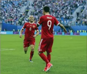  ?? PAVEL GOLOVKIN — THE ASSOCIATED PRESS ?? Russia’s Fedor Smolov, right, celebrates with Denis Glushakov after scoring his side’s second goal during the Confederat­ions Cup, Group A match against New Zealand on Saturday.