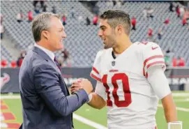  ?? Tim Warner/ Getty Images 2017 ?? General manager John Lynch congratula­tes quarterbac­k
Jimmy Garoppolo after the
49ers defeated the Texans 26-16
at NRG Stadium in Houston on Dec. 10, 2017.
It was the second of five
straight victories to end the
season.