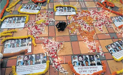  ?? Picture: AFP ?? TOUCHING GESTURE: An Indian photojourn­alist lights a candle during a vigil for 10 Afghan journalist­s who were killed in a targeted suicide bombing and on the eve of World Press Freedom Day in Kolkata on Wednesday