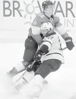  ?? WILFREDO LEE/AP ?? Bruins center Patrice Bergeron collides with Panthers center Noel Acciari on Thursday.