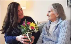  ?? Brian A. Pounds / Hearst Connecticu­t Media ?? Holly Batti, of Ridgefield, brings flowers to her mother, Gwenn Fiorito, who lives in memory care at Greens at Cannondale in Wilton last week.