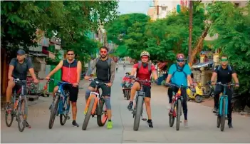  ??  ?? Bicyclists from Hyderabad stand for a picture before riding off.