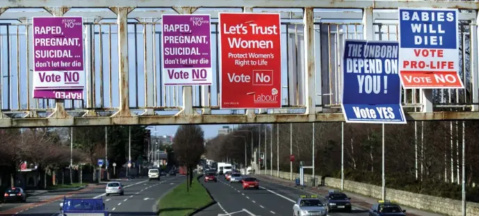  ??  ?? Campaign posters for both sides of the debate before the 2002 referendum — just one of four put in front of the electorate in the last 35 years – at a flyover in Donnybrook in Dublin