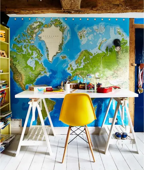  ??  ?? COLOUR FOCUS A world map and zingy yellow chair create a fun look in the boys’ room
WET ROOM
Just off the hall is a wet room that continues the traditiona­l-meetsconte­mporary theme with Victorian-style encaustic floor tiles and crisp white Metro wall...