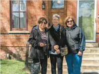  ?? ?? Childhood friends Beverly Bravo, from left, Anita Ferguson and Denise Fattori-Alcantar, who grew up in Pullman, stand outside the Americo Lisciotto home in Chicago’s Pullman neighborho­od.