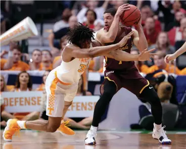  ?? Associated Press ?? ■ Tennessee forward Yves Pons (35) dives while trying to intercept a pass to Loyola-Chicago guard Lucas Williamson (1) during the first half of a second-round game at the NCAA men's college basketball tournament Saturday in Dallas.