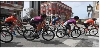  ?? (NWA Democrat-Gazette/J.T. Wampler) ?? Profession­al women cyclists race through downtown Fayettevil­le on April 7 during the Joe Martin Stage Race. This year’s event, scheduled for the first week of April, has been postponed because of the coronaviru­s pandemic. No new race date has been announced.