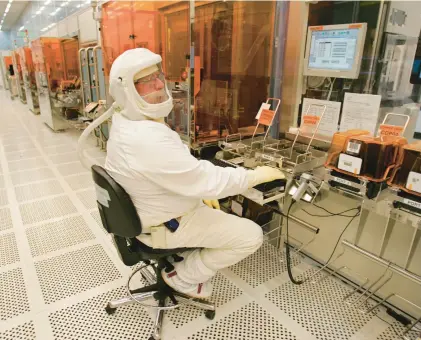  ?? PAUL SAKUMA/AP ?? An Intel Corp. manufactur­ing technician produces Intel chips in a clean room in Santa Clara, California. The CHIPS Act, which was passed a year ago, is intended to spur semiconduc­tor production across the U.S.