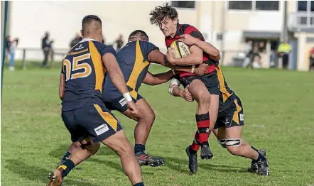  ??  ?? Hamilton Old Boys player Tom Jordan tries to bust through the Otorohanga defenders. Jordan is the current points leader in the premier club rugby competitio­n. HOB won 21-17.