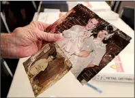  ?? NWA Media/BEN GOFF ?? Cindy Atteberry holds up a photo of her son, Mike Burke, as a teenager and one with his wife, Vickie, and daughter, Ashley. The images were recovered from the debris of the 2011 tornado in Joplin, Mo. Atteberry on Saturday claimed three photos from a...