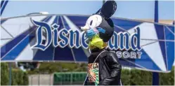  ??  ?? In this file photo a make shift Mickey Mouse on top of a car circles around Disneyland Resort calling for higher safety standards before its reopening, amid the coronaviru­s pandemic in Anaheim, California. — AFP