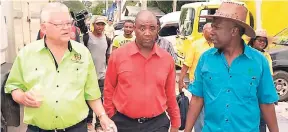  ??  ?? From left: Minister of Industry, Commerce, Agricultur­e and Fisheries Karl Samuda, Peter Thompson – CEO RADA, Norman Grant – JAS president, tour Denbigh Show 2016.