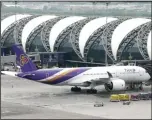  ??  ?? In this file photo, a Thai Airways jet parks at Suvarnabhu­mi Airport in Bangkok,
Thailand. (AP)