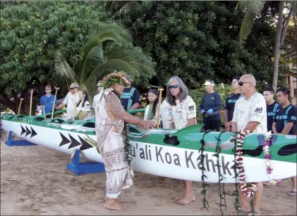  ?? Ella Loui photos ?? Community members, combat military veterans and Maui Vet Center outreach workers gather for a blessing of the first Pu‘ali Koa Kahiko six-man canoe early Friday morning at Bullyland, between Sugar Beach Resort and Maui Canoe Club, where the canoe will be housed.