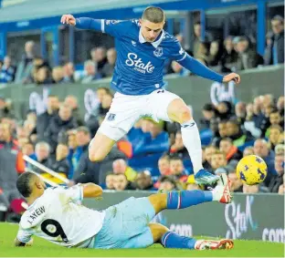  ?? AP ?? Crystal Palace’s Jordan Ayew (bottom) slides in for a challenge on Everton’s Vitaliy Mykolenko during their English Premier League football match yesterday at the Goodison Park stadium in Liverpool, England. The game ended 1-1.
