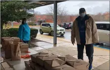  ??  ?? Brandywine teacher Joyce Esser, left, and veteran Bill Stoudt helped hand out meals.