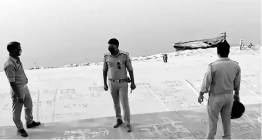  ?? AP ?? This frame grab from video provided by KK Production­s shows police officials standing guard at the banks of the river where several bodies were found lying in Ghazipur district, Uttar Pradesh state, India, on Tuesday.