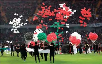  ??  ?? Performers release balloons during a ceremony ahead of a football match between Iraq and Lebanon in the West Asian Championsh­ip at the Karbala Sports City stadium.