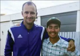  ?? SARAH PRINCE — THE ASSOCIATED PRESS ?? American adventurer John Allen Chau, right, stands for a photograph with Founder of Ubuntu Football Academy Casey Prince, 39, in Cape Town, South Africa, days before he left for in a remote Indian island of North Sentinel Island, where he was killed. Chau, who kayaked to the remote island populated by a tribe known for shooting at outsiders with bows and arrows, has been killed, police said Wednesday, Nov. 21. Officials said they were working with anthropolo­gists to recover the body.