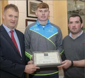  ??  ?? Ben Maddock receives the first Jack Pettit Memorial Sports Scholarshi­p from John Banville, vice principal, St. Peter’s College, and Paul O’Brien of DCU.