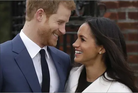  ?? MATT DUNHAM — THE ASSOCIATED PRESS FILE ?? Britain’s Prince Harry and his fiancee Meghan Markle pose for photograph­ers in the grounds of Kensington Palace in London. Prince Harry and Meghan Markle will tie the knot at St. George’s Chapel in Windsor, southern England on May 19, with about 600...